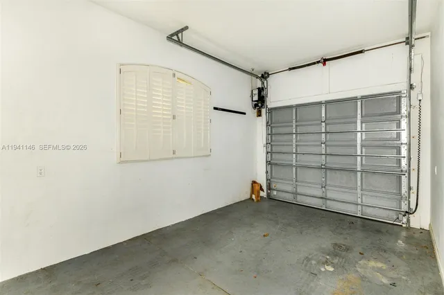 a front view of a house with a garden and plants