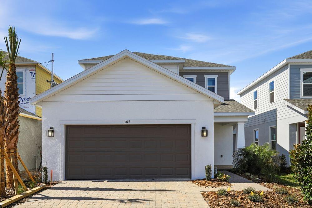 a front view of a house with garage