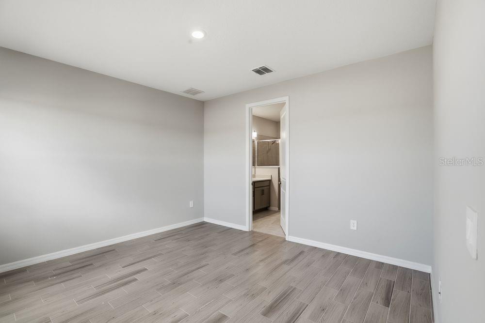 1014 Top Minnow Road St. Cloud, FL 34771 - Photo 11 of 39 a view of an empty room with wooden floor and closet