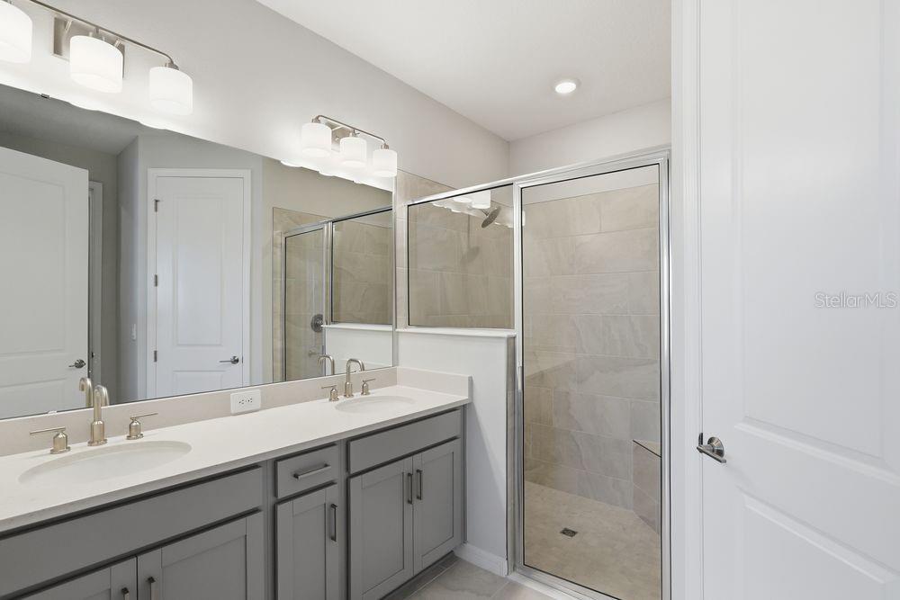1014 Top Minnow Road St. Cloud, FL 34771 - Photo 12 of 39 a bathroom with double vanity sink and shower