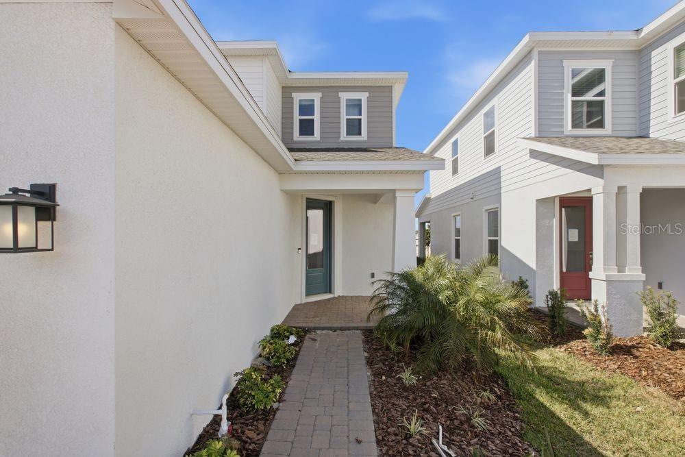 1014 Top Minnow Road St. Cloud, FL 34771 - Photo 2 of 39 a front view of a house with garden