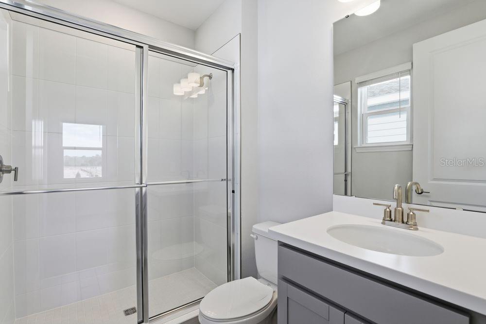 1014 Top Minnow Road St. Cloud, FL 34771 - Photo 22 of 39 a bathroom with a sink toilet and shower