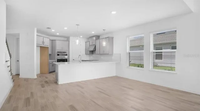 a view of a room with wooden floor