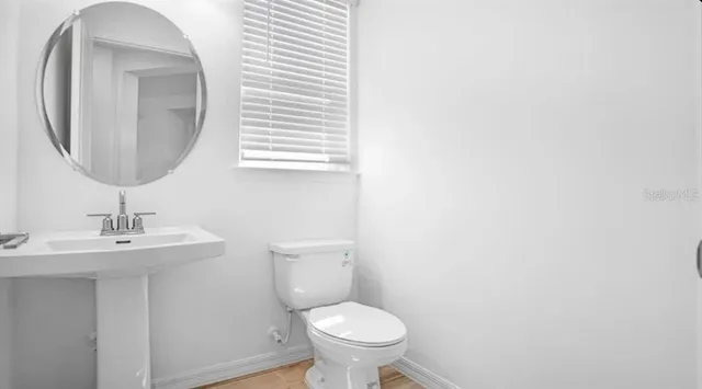 a bathroom with a shower sink vanity and mirror