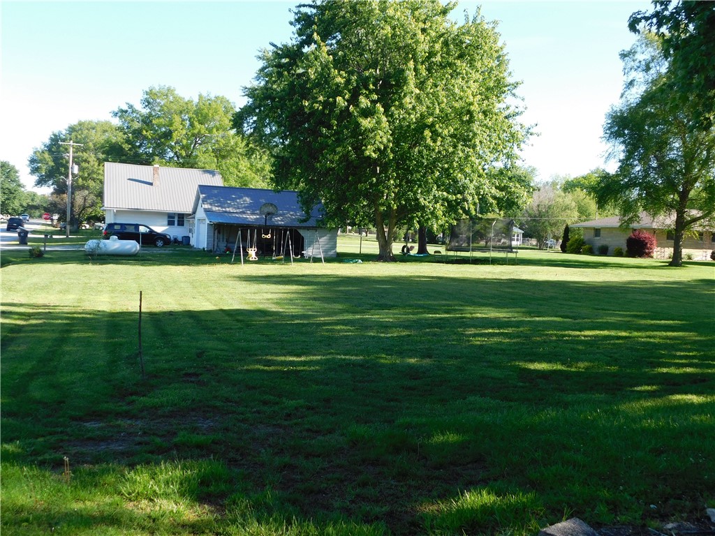 1301 East Main Street Casey, IL 62420 - Photo 10 of 14 a house view with a play ground and large trees
