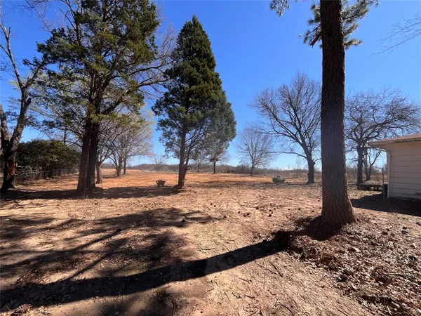 a view of a yard covered with snow in front of house