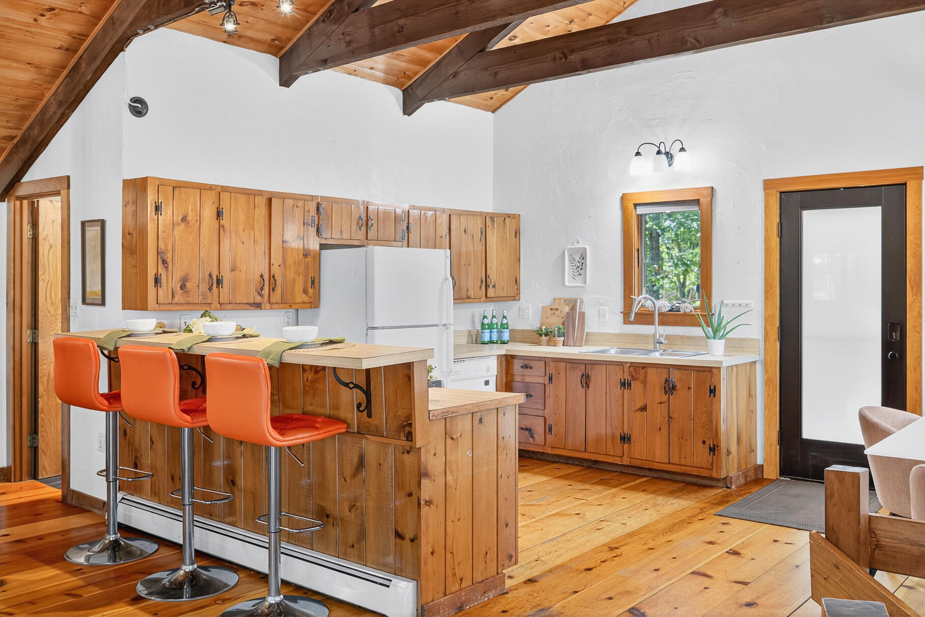 90 Blue Heron Road Wellfleet, MA 02667 - Photo 14 of 54 a kitchen with cabinets a sink and chairs