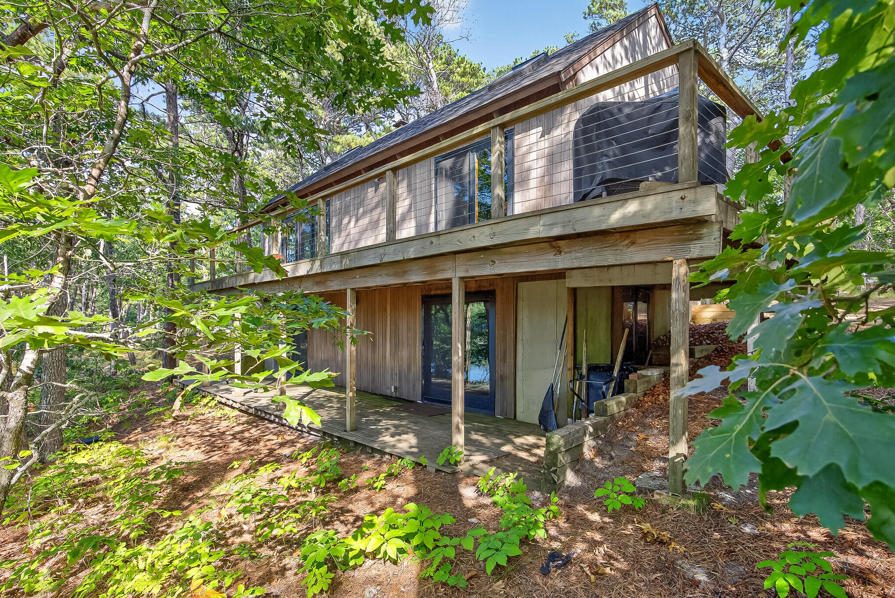 90 Blue Heron Road Wellfleet, MA 02667 - Photo 4 of 54 front view of a house with a yard