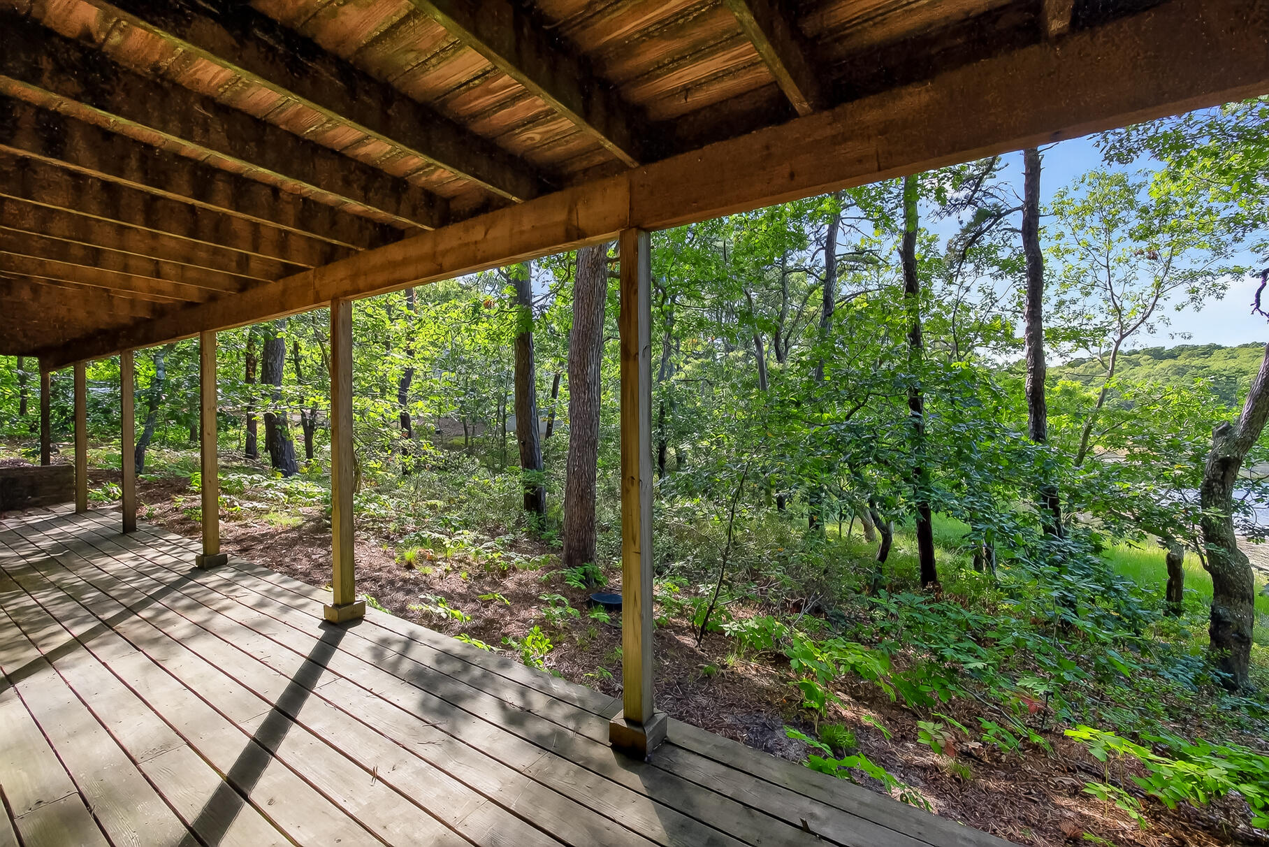 90 Blue Heron Road Wellfleet, MA 02667 - Photo 41 of 54 a view of a backyard with wooden floor