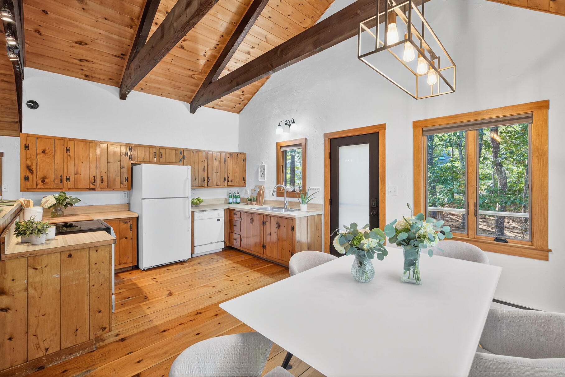 90 Blue Heron Road Wellfleet, MA 02667 - Photo 9 of 54 a kitchen with a table chairs and refrigerator