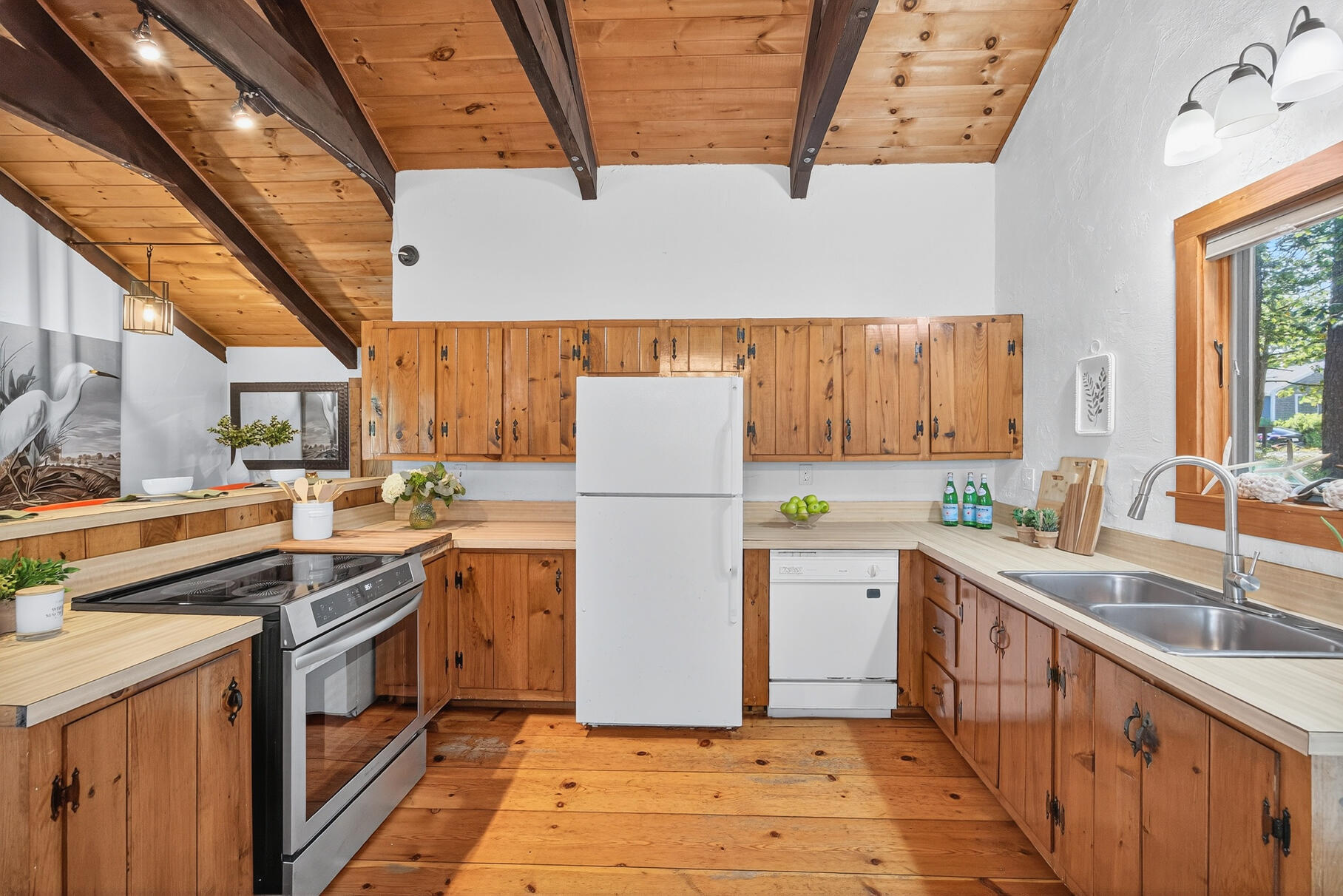 90 Blue Heron Road Wellfleet, MA 02667 - Photo 10 of 54 a kitchen with a stove sink and cabinets