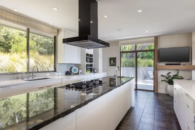 a large kitchen with a table and chairs
