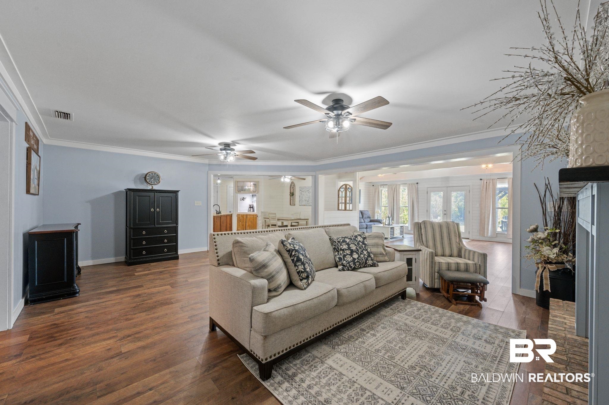 20037 County Road 33 Fairhope, AL 36532 - Photo 7 of 79 Living room featuring ceiling fan, ornamental molding, a brick fireplace, and dark hardwood / wood-style floors