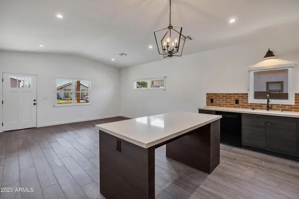 a kitchen with a wooden floor and a refrigerator