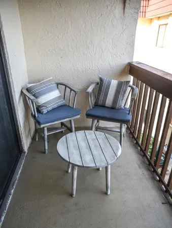a living room with chairs and a table