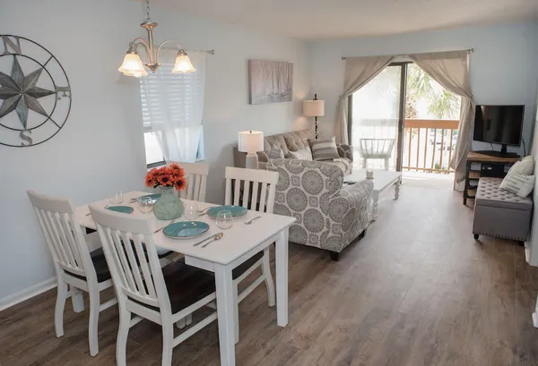 a view of a dining room with furniture window and wooden floor