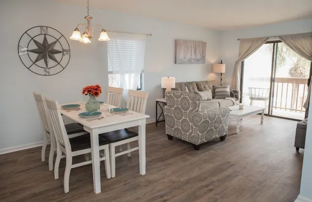 a living room with furniture dining table and a large window