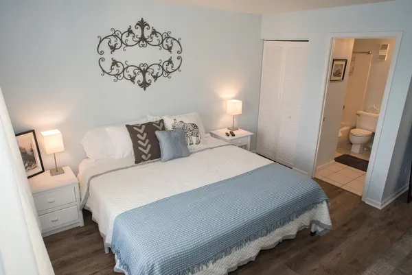 a bedroom with a bed and wooden floor