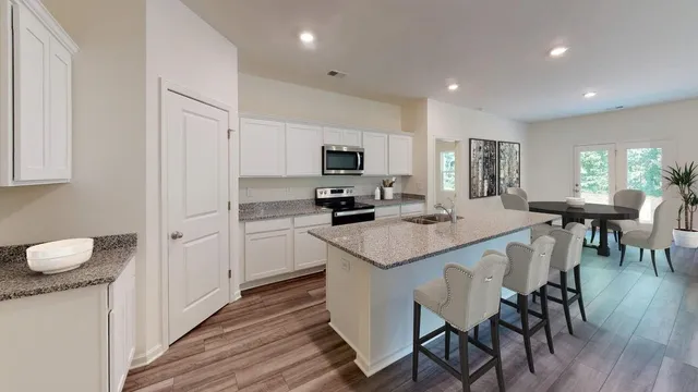 a kitchen with a sink a microwave and cabinets