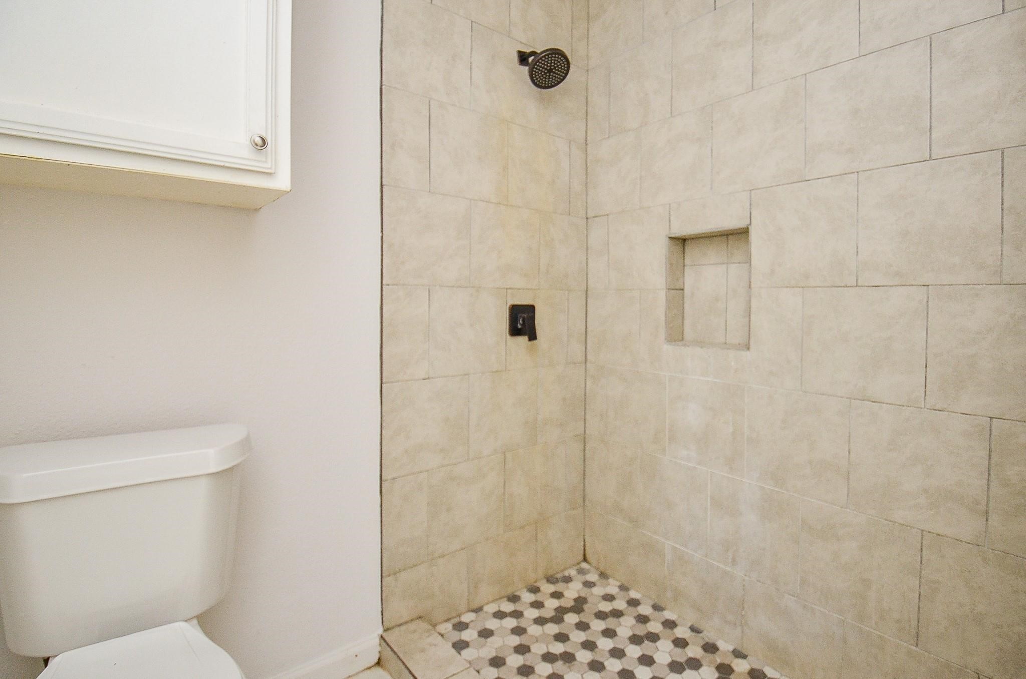 11818 Spring Grove Drive Houston, TX 77099 - Photo 11 of 18 a bathroom with a toilet and a shower