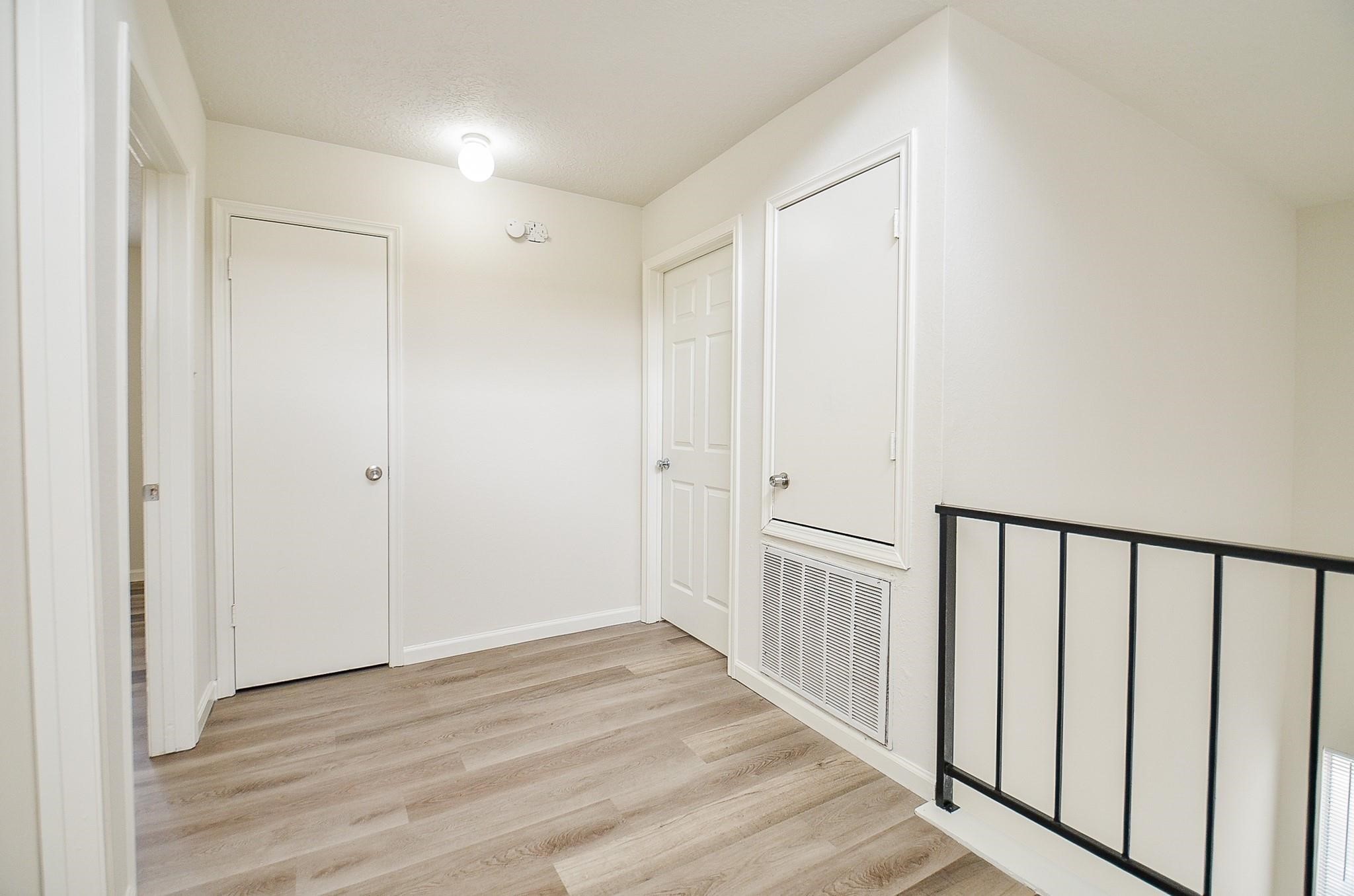 11818 Spring Grove Drive Houston, TX 77099 - Photo 14 of 18 a view of a hallway with wooden floor