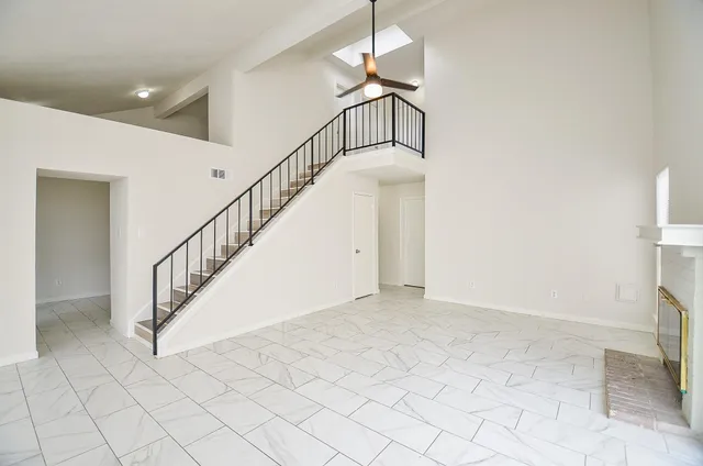 a view of staircase with white walls and railing
