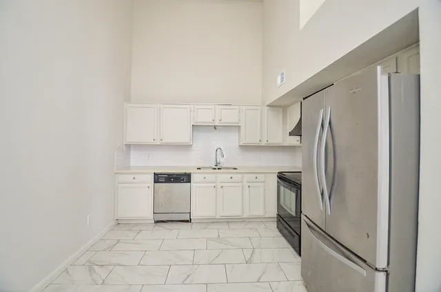 an empty room with white walls and tiles