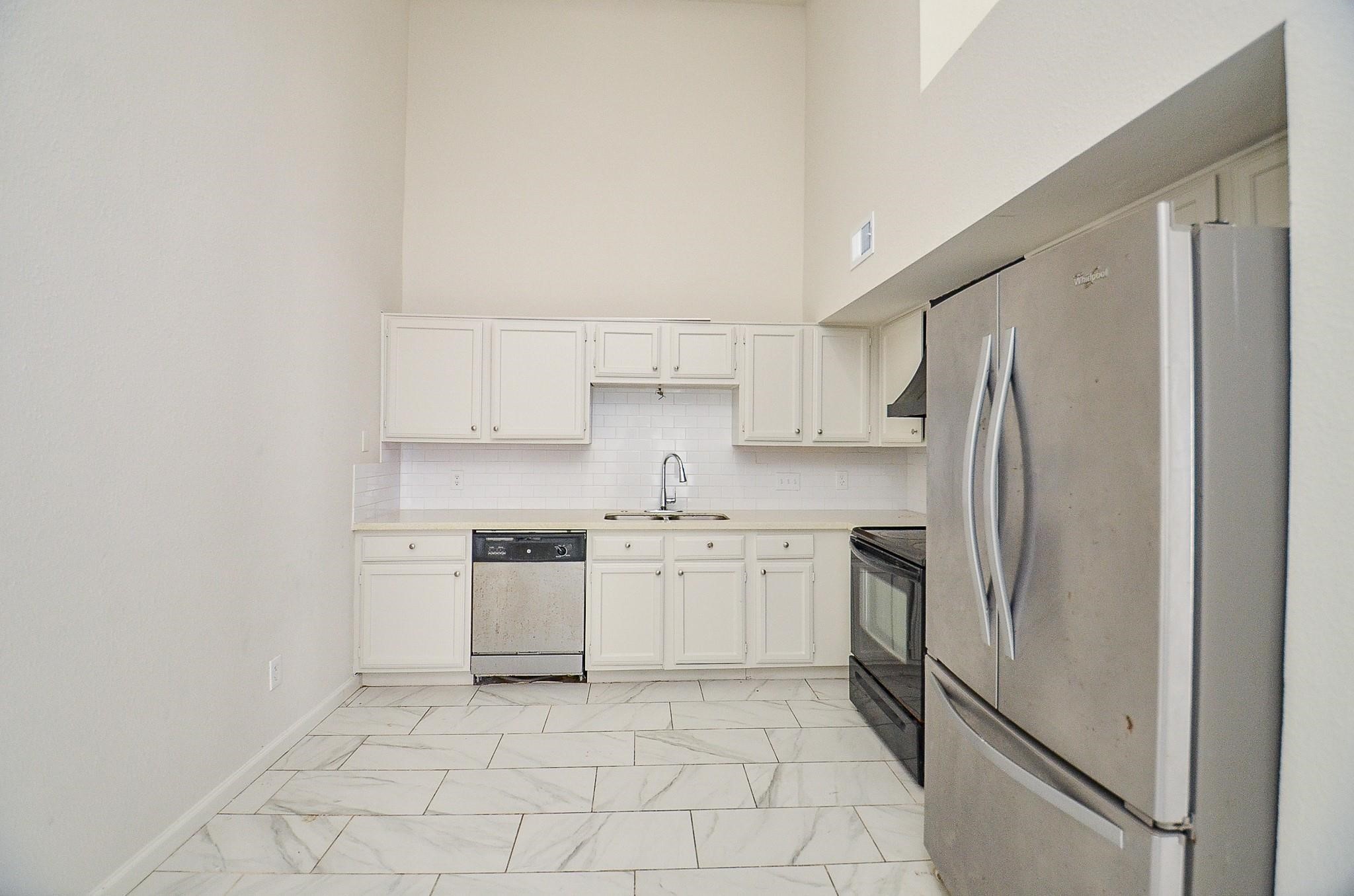 11818 Spring Grove Drive Houston, TX 77099 - Photo 7 of 18 a kitchen with stainless steel appliances granite countertop a refrigerator sink and stove