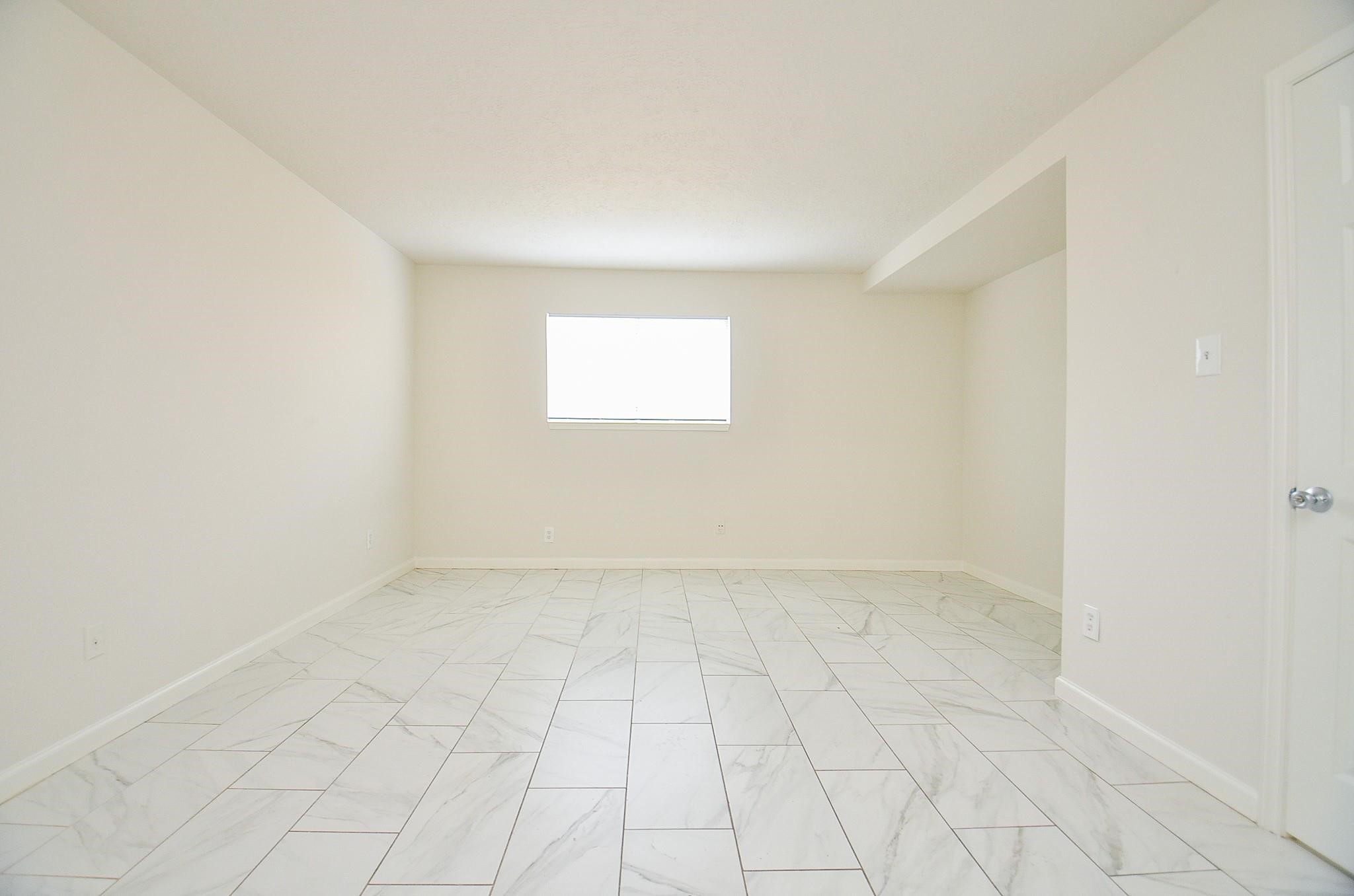 11818 Spring Grove Drive Houston, TX 77099 - Photo 8 of 18 an empty room with white walls and tiles
