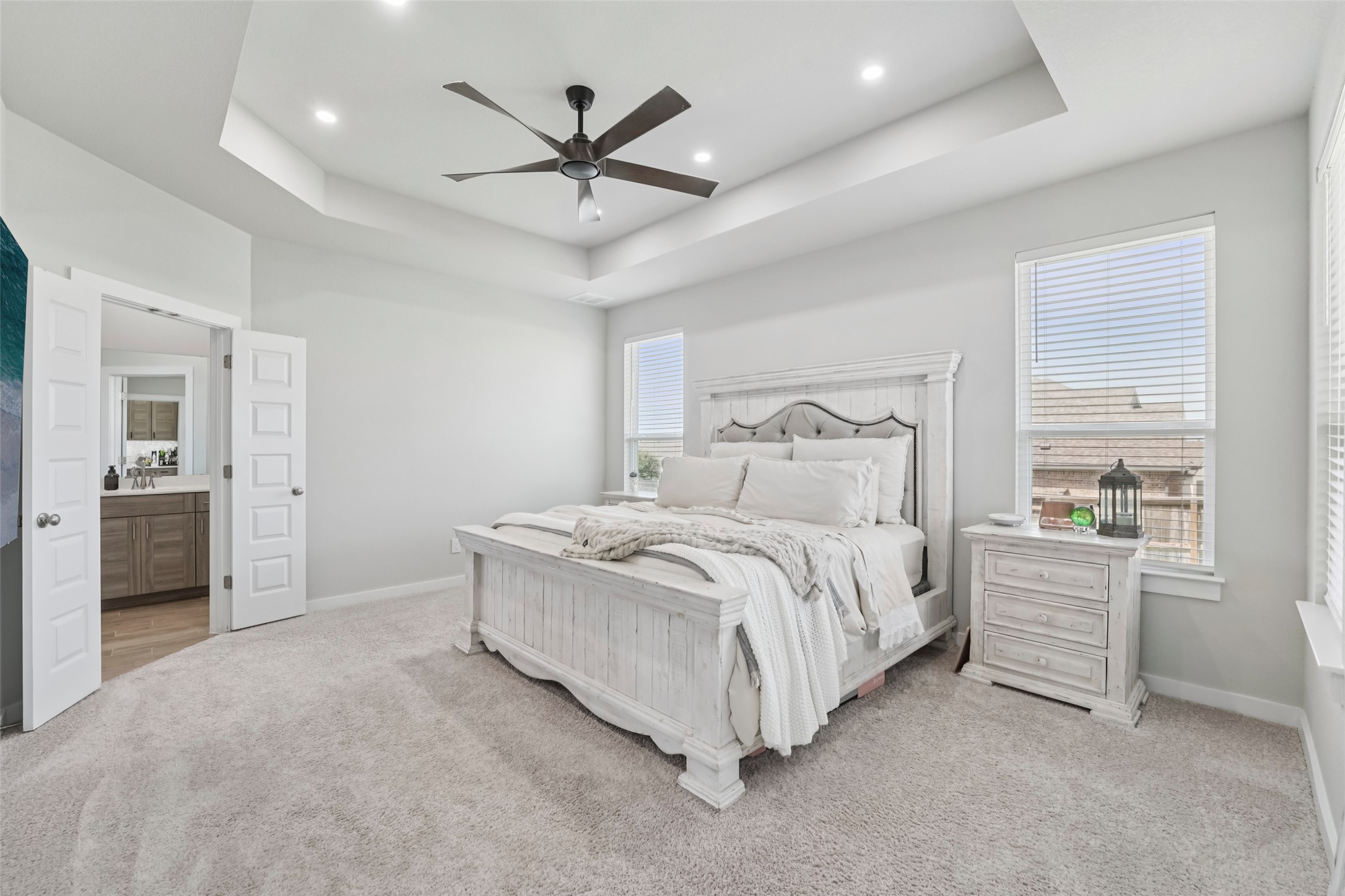 1108 Sweetspire Street Leander, TX 78641 - Photo 21 of 39 Bedroom with a tray ceiling, light carpet, recessed lighting, and ceiling fan
