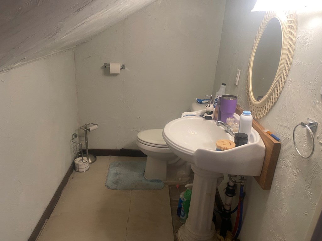 1760 Jordan Hollow Road Parker, PA 16049 - Photo 20 of 52 a bathroom with a sink toilet and a mirror