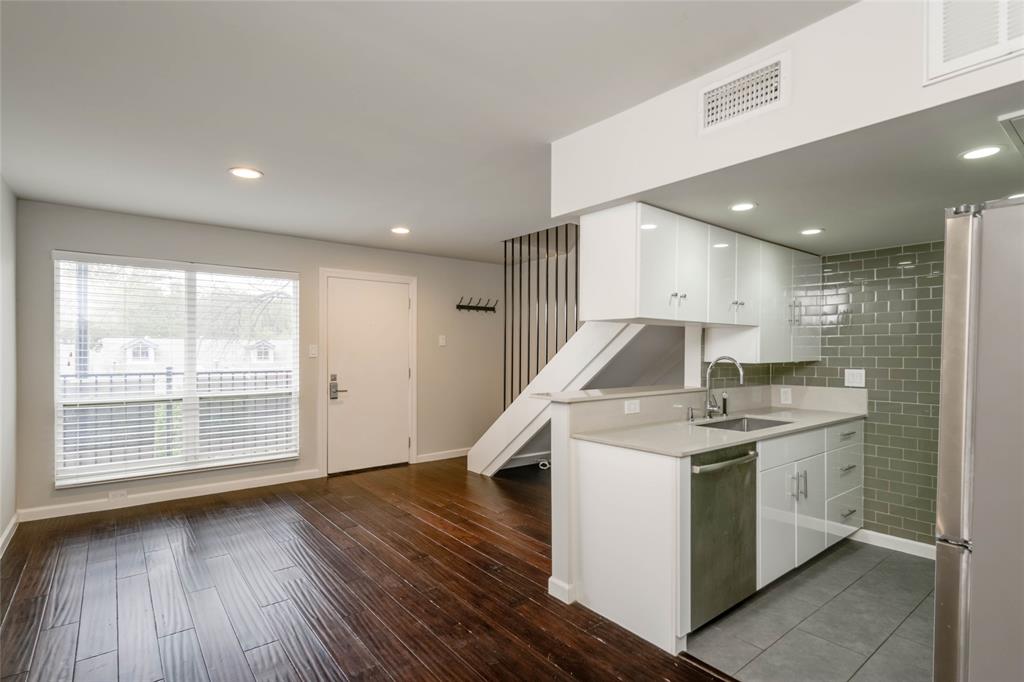 3110 Red River Street, Unit 220 Austin, TX 78705 - Photo 3 of 8 a kitchen with a sink and wooden floor