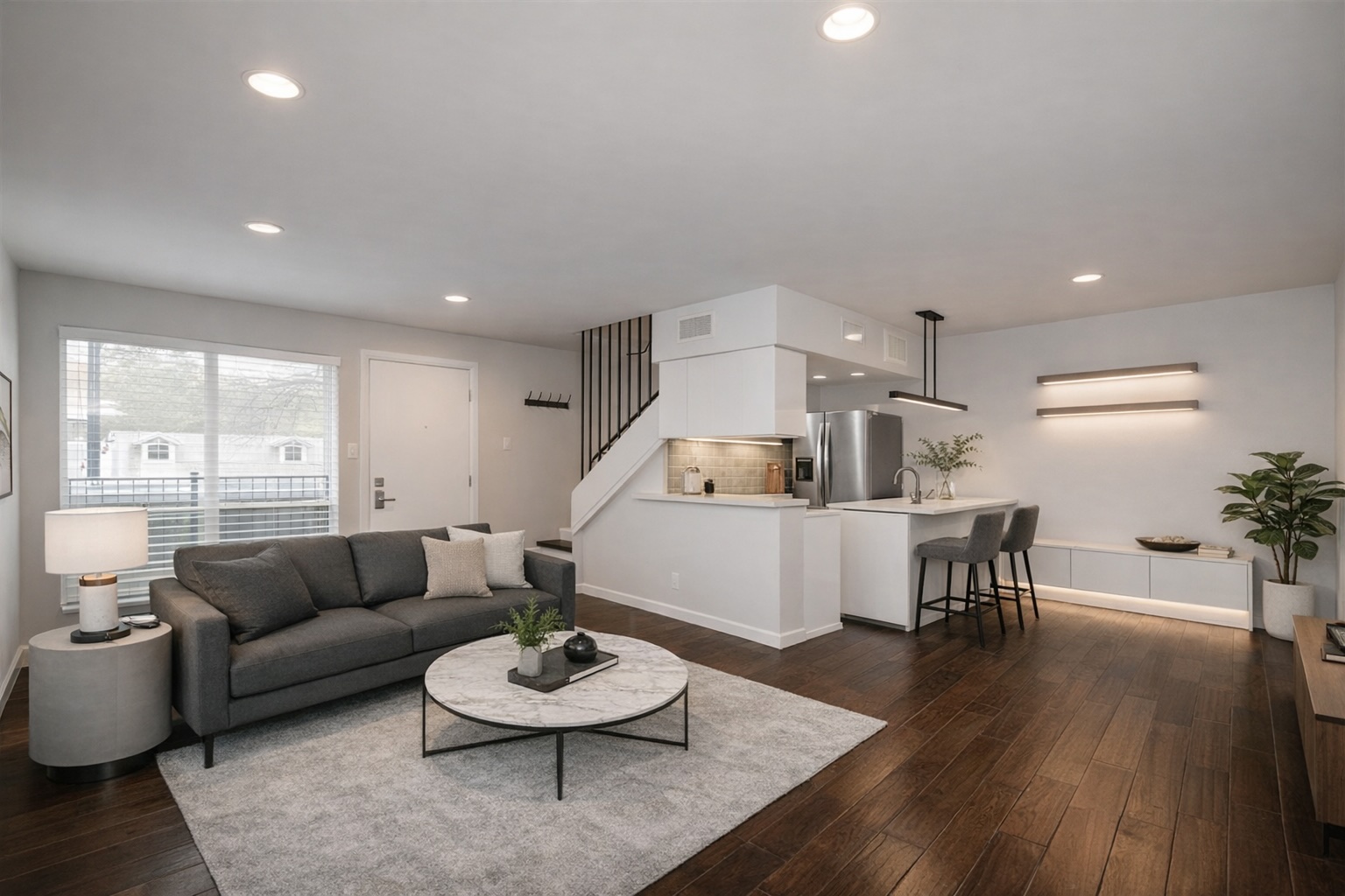 3110 Red River Street, Unit 220 Austin, TX 78705 - Photo 5 of 7 a living room with furniture and a wooden floor