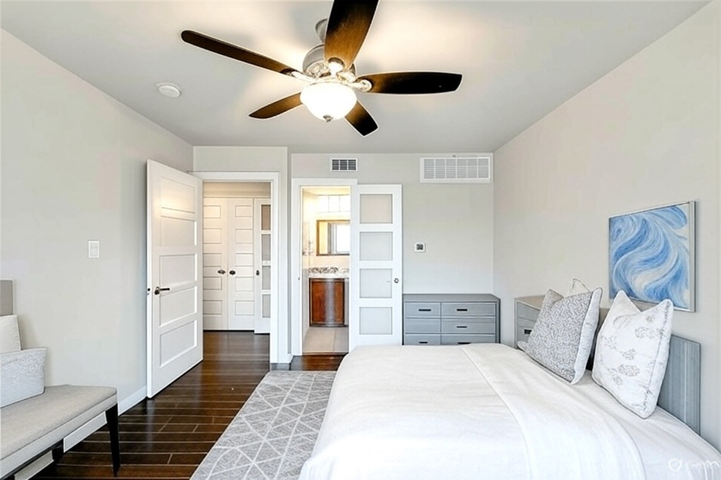 3110 Red River Street, Unit 220 Austin, TX 78705 - Photo 5 of 8 a spacious bedroom with a large bed and ceiling fan