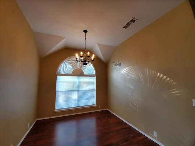 a view of a room window and wooden floor