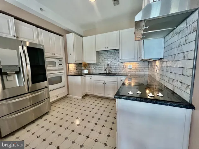 a kitchen with a sink a stove and cabinets
