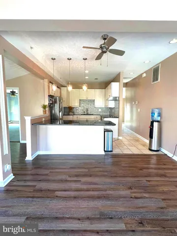 a view of kitchen with cabinets and wooden floor