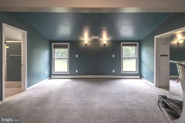 an empty room with windows and entrance