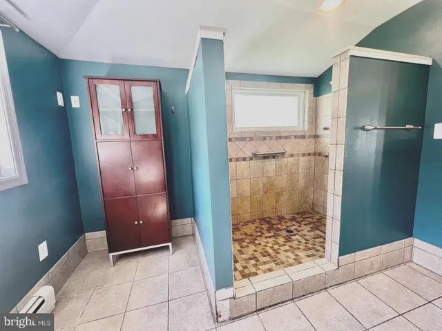 a bathroom with a glass shower door