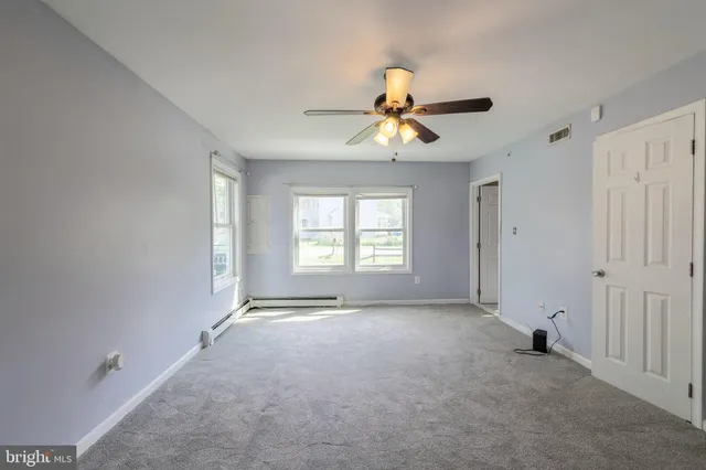 a view of a livingroom with a window and a ceiling fan