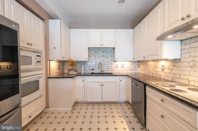 a kitchen with a sink a stove and refrigerator