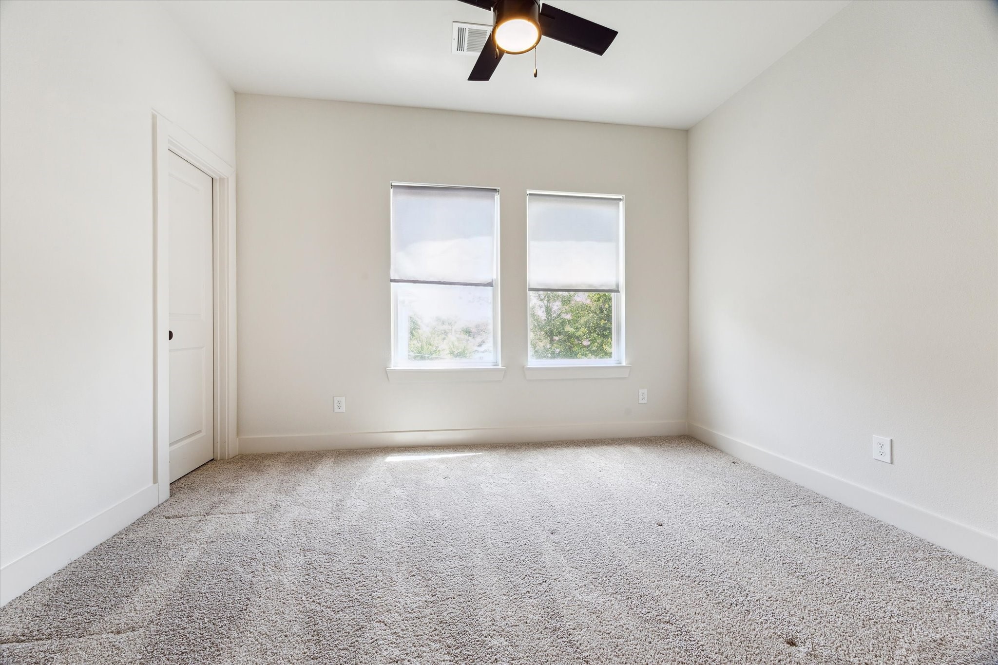 4155 Griggs Road Houston, TX 77021 - Photo 11 of 17 Bright and airy secondary bedroom featuring plush neutral carpeting, a stylish ceiling fan, and an abundance of natural light.