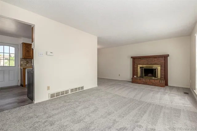 an empty room with fireplace