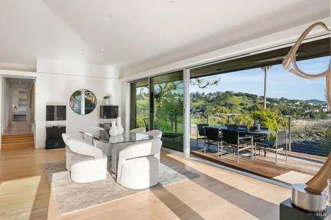 a view of a balcony with a floor to ceiling window and wooden floor