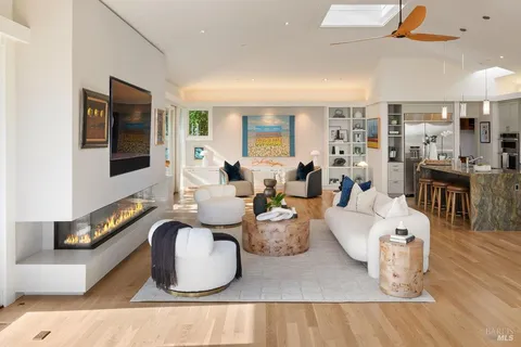 a kitchen with kitchen island granite countertop a sink and refrigerator