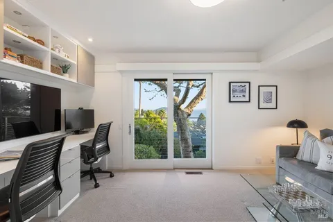 a bedroom with a bed and a refrigerator