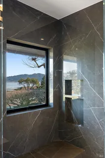 a spacious bathroom with a granite countertop sink toilet and shower
