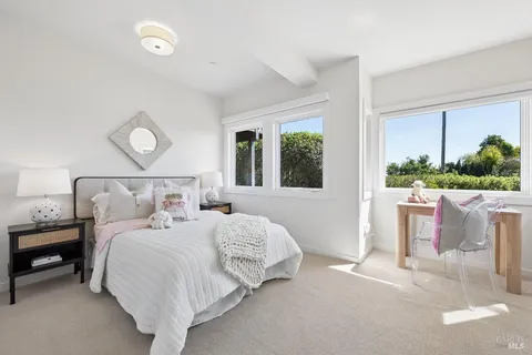 a bedroom with bed and a large window