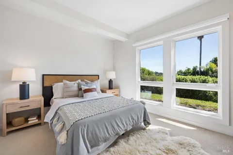 a view of a livingroom with workspace and a window