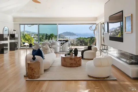 a living room with fireplace furniture and a flat screen tv